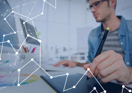 Network of connections against caucasian man using graphic tablet at office. global networking and...