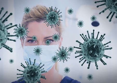 Multiple covid-19 cells floating against portrait of female health worker wearing face mask. coronavirus covid-19 pandemic conceptの写真素材