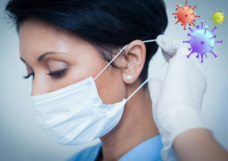Multiple covid-19 cells against close up of female doctor wearing face mask against white...