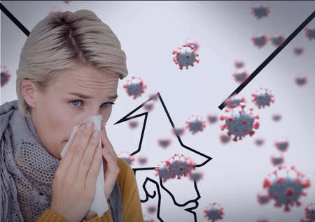 Composition of covid 19 cells and sick woman blowing her nose. global coronavirus pandemic and health concept digitally generated image.の写真素材