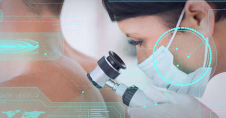 Medical data processing against female doctor wearing face mask examining back of male patient. medical research and technology conceptの写真素材