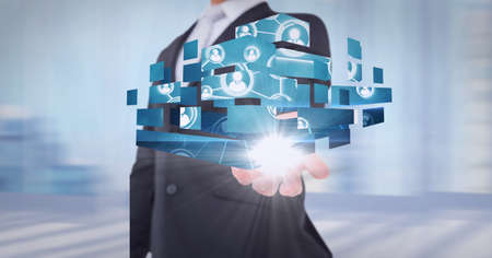 Composition of network of digital people icons over hand of businessman. global technology and...