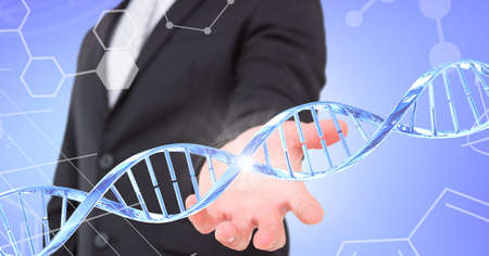 Dna structure and chemical structures over mid section of business man with cupped hand. global business and medical research technology conceptの写真素材