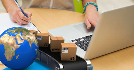 Earth and packages on conveyor belt with woman working in the background. environment and delivery...