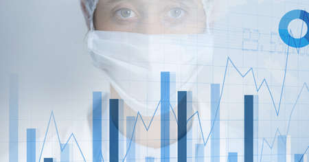 Financial data and graphs over a medical worker, healthcare and economy concept. digitally generated image.の写真素材