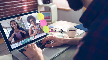 Photography apps against midsection of creative editor typing on laptopの写真素材
