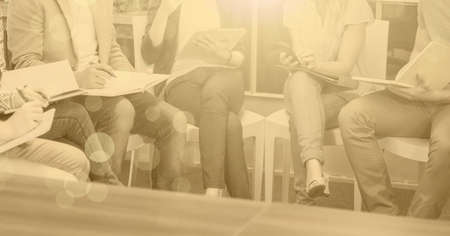 Composition of light circles over group of businesspeople working. global business, finance and...