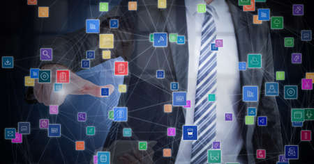 Composition of businessman touching screen with network of online digital icons. global online business, networking and digital interface concept digitally generated image.の写真素材