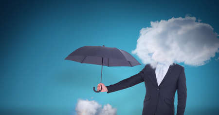 Cloud covering face of businessman holding an umbrella against blue background. cloud storage and...