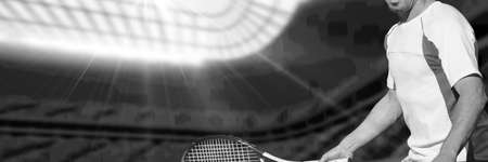 Composition of midsection of man playing tennis over sports stadium in black and white. sports and active lifestyle concept digitally generated image.の写真素材