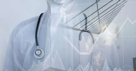 Composition of medical data processing over doctor in ppe suit. global covid 19 pandemic, medicine, digital interface and data processing concept digitally generated image.の写真素材