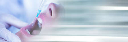 Composition of close up of female patient receiving local anaesthetics with blurred light trails....