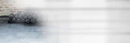 Composition of stack of dumbbells on gym floor with blurred grey light. exercise, gym equipment and...