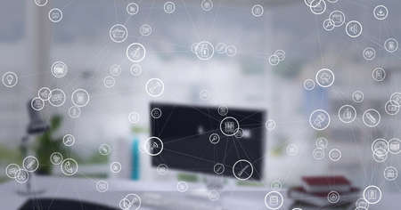 Composition of network of digital icons with out of focus office in background. global connections and digital interface concept digitally generated image.の写真素材