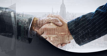 Composition of businessmen shaking hands over cityscape. business, finance, negotiations and success concept digitally generated image.の写真素材