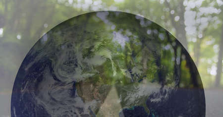 Composition of globe over road and green forest. global environment, sustainability, networking and connections concept digitally generated image.の写真素材