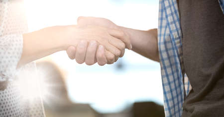 Composition of man and woman shaking hands. greeting, deal, success and agreement concept digitally generated image.の写真素材