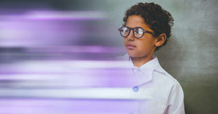Composition of schoolboy with protective glasses in school laboratory with purple motion blur. science, learning and knowledge concept digitally generated image.の写真素材