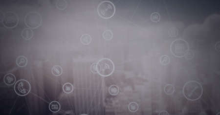 Network of digital icons over cityscape against grey background. global networking and business technology conceptの写真素材