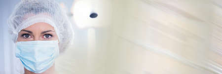 Composition of female dentist wearing face mask in surgery with blurred light trails. dentistry...
