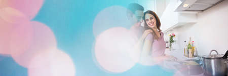 Composition of caucasian couple cooking in kitchen with spots of light. cooking and romance concept concept digitally generated image.の写真素材