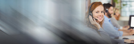 Composition of happy caucasian businesswoman wearing phone headset in office with motion blur. business, work, technology and communication concept digitally generated image.の写真素材