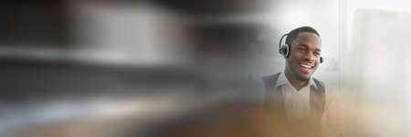 Composition of happy african american businessman wearing phone headset in office with motion blur....