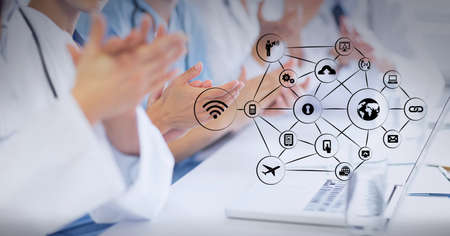 Composition of network of digital icons over midsection of clapping doctors. medicine, success and...