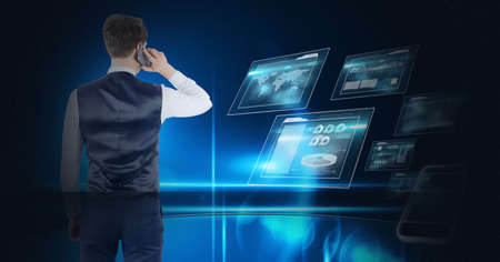 Composition of businessman talking on smartphone over digital screens with data processing. global...