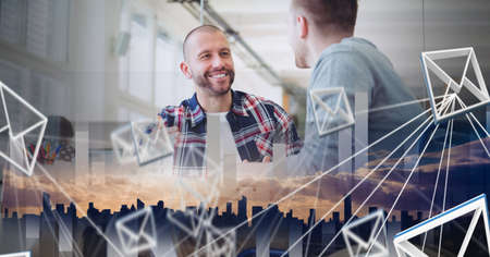 Composition of network of email icons over two businessmen talking in office. global online...