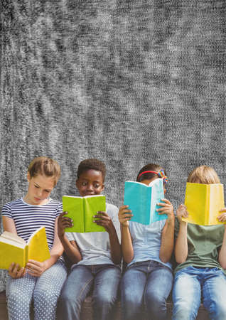 Composition of group of schoolchildren reading holding books on grey background. education and back to school concept digitally generated image.の写真素材