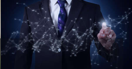 Network of connections against mid section of businessman touching invisible screen. global networking and technology conceptの写真素材