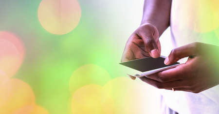 Composition of light circles over african american man using smartphone. global communication and...