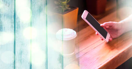 Composition of light circles over caucasian woman using smartphone in cafe. global communication and...