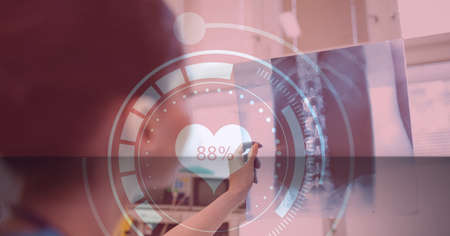 Heart rate monitor against female examining x-ray report at hospital. medical research and technology conceptの写真素材