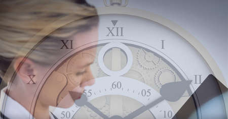 Close up of clock against caucasian female doctor examining x-ray report. medical research and...