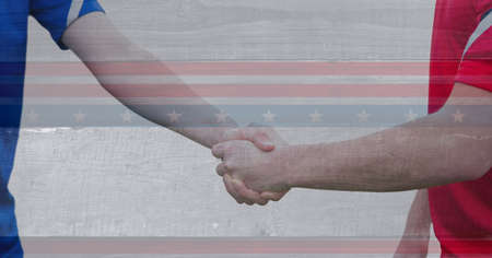 Digital composite image of american flag against mid section of two sportsmen shaking hands. patriotism and sports conceptの写真素材