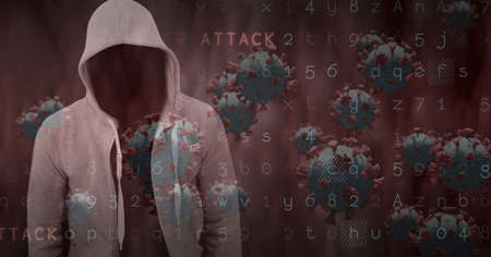 Composition of hooded hacker with covid cells and cyber attack security warning on dark screen. global coronavirus pandemic and cyber security concept digitally generated image.の写真素材
