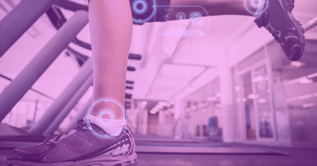 Composition of digital interface over woman&#39;s legs exercising on treadmill with pink tint. technology, sport, fitness and active lifestyle concept digitally generated image.の写真素材