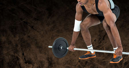 Composition of low section of strong african american man lifting barbell with copy space. sport, fitness and active lifestyle concept digitally generated image.の写真素材