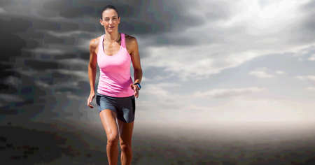 Composition of fit caucasian female athlete running with copy space on clouds background. sport,...