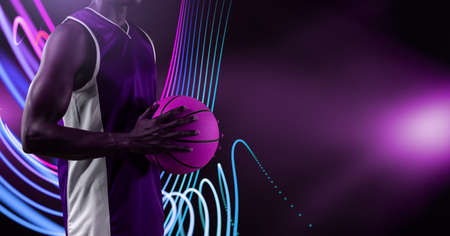 Composition of athletic male basketball player with ball on black background. sport, fitness and active lifestyle concept digitally generated image.の写真素材