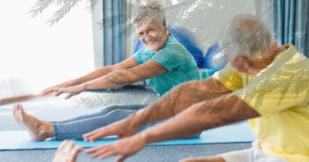 Composition of senior couple practicing yoga and trees in sunlight. healthy active retirement...