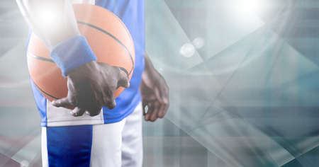 Composition of midsection of basketball player holding ball with copy space. sport and competition concept digitally generated image.の写真素材