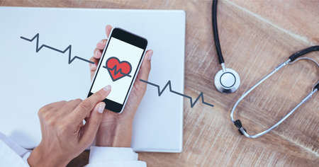 Composition of screen with red heart icons over female doctor using smartphone. global online medicine and technology concept digitally generated image.の写真素材