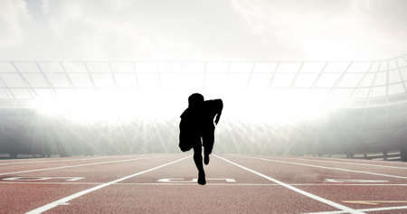 Composition of silhouette of man running on stadium over light blur. sport, fitness and active lifestyle concept digitally generated image.の写真素材