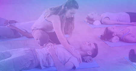 Composition of man and women practicing yoga on purple tinted background. exercise, wellbeing and active lifestyle concept digitally generated image.の写真素材