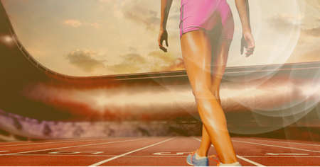 Composition of legs of female runner on racing track with spots of light. sport and competition...