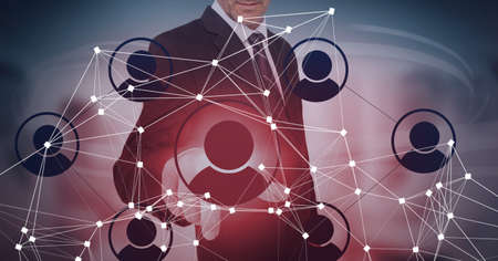 Composition of businessman touching interactive screen with icons. global networks and digital interface concept digitally generated image.の写真素材