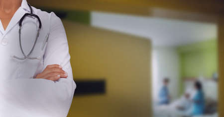 Doctor wearing white blouse and stetoscop with couple having baby. hospital background concept. digitally generated imageの写真素材